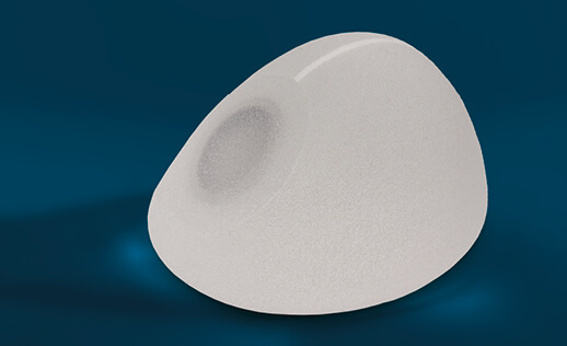 A POLYTECH anatomical silicone implant with a textured surface, displayed against a dark blue background.